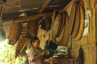 Woman surrounded with traditional bamboo-woven items